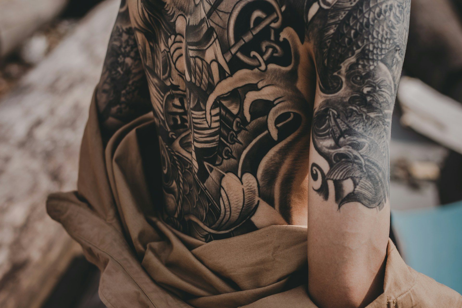 Tattoo artist applying bold traditional American tattoo design